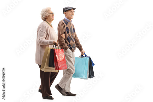 Senior couple with shopping bags walking