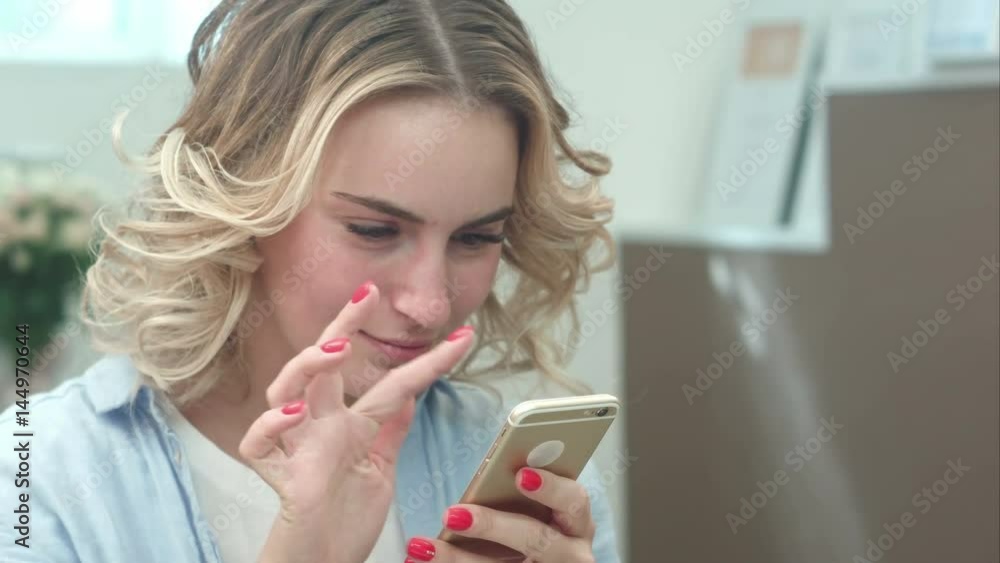 Surprised woman watching screen of mobile phone Surprised woman watching screen of mobile phone