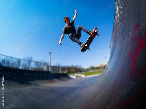 Skateboarder doing ollie on ramp