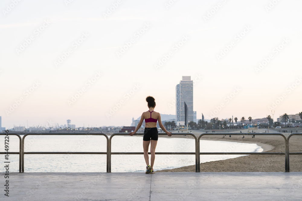 Spain, Barcelona, back view of young jogger Spain, Barcelona, back view of young jogger