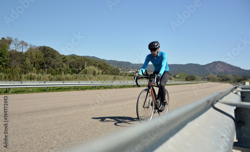 cyclist training on a lonely road