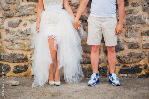 Female and male feet on the pavement. Wedding in Montenegro