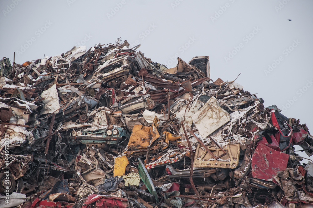 Huge pile of car parts and smashed old cars in a auto cemetery on a winter day Huge pile of car parts and smashed old cars in a auto cemetery on a winter day