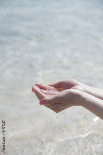 a hand which is trying to hold a water from the sea © 김대수 김대수