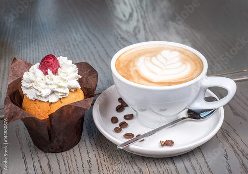 Coffee cappuccino and dessert on wooden table