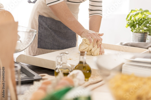 Woman kneading the dough