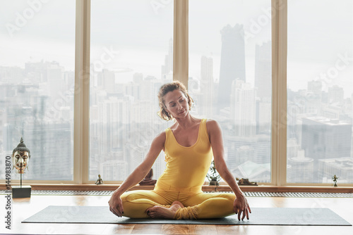 Healthy young woman doing meditation at home