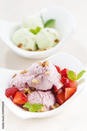 strawberry and pistachio ice cream on white table, vertical