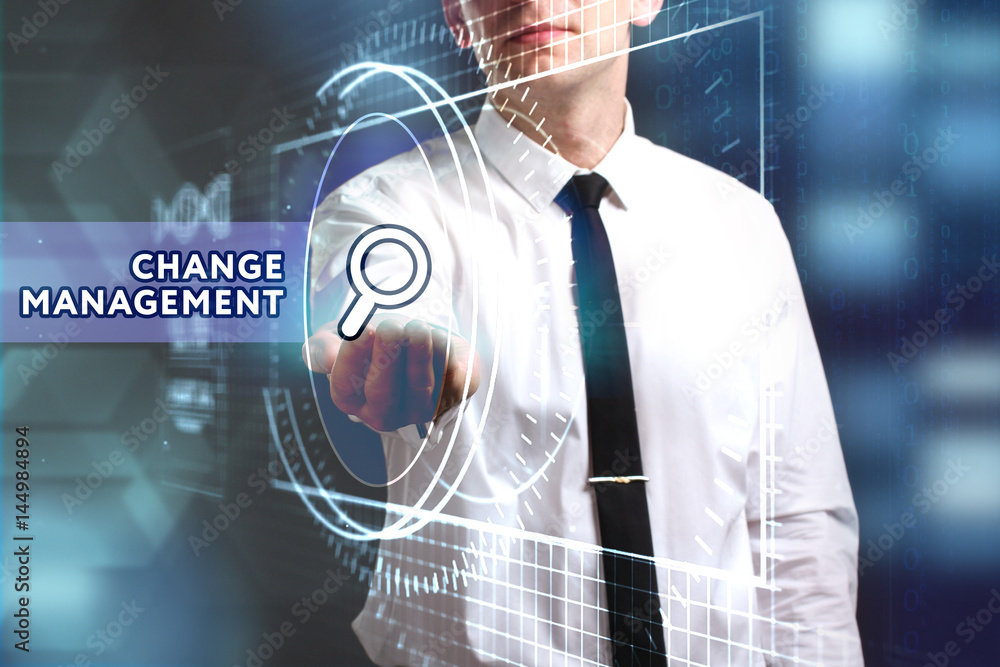 Business, Technology, Internet and network concept. Young businessman working on a virtual screen of the future and sees the inscription: Change management Business, Technology, Internet and network concept. Young businessman working on a virtual screen of the future and sees the inscription: Change management