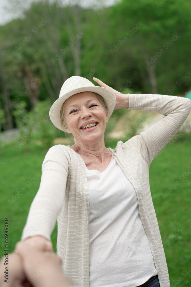 Portrait of cheerful senior woman laughing outloud