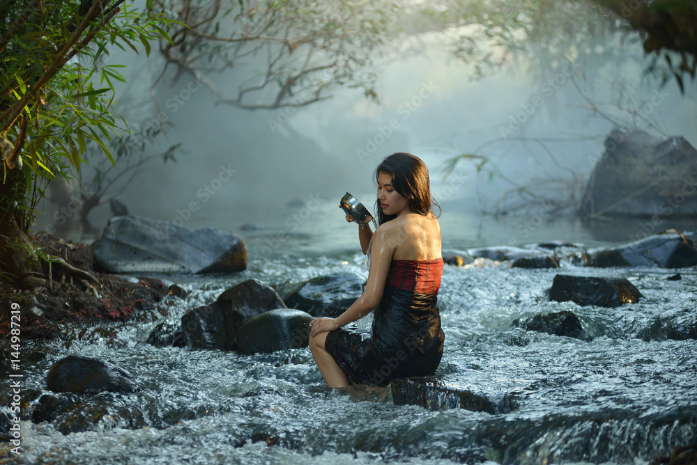 young woman relaxing in hot springs,Woman enjoy onsen in Thailand,Asian