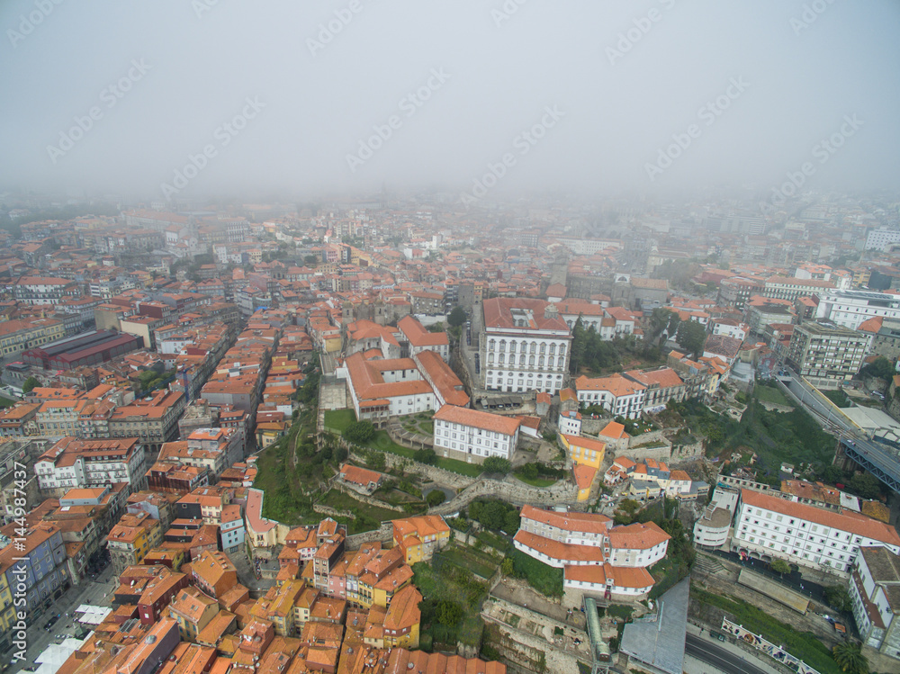 Flight over the narrow streets of the old town of Porto at the fog Flight over the narrow streets of the old town of Porto at the fog