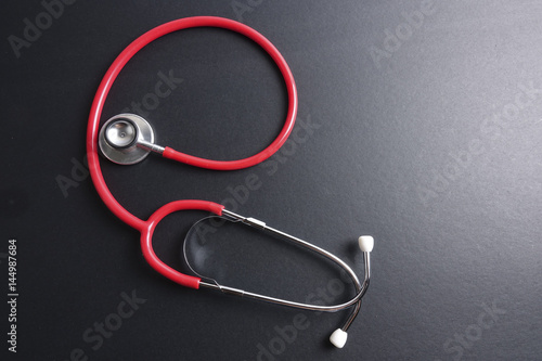 Red stethoscope,keyboard ,puzzle and coins. Medical concept.