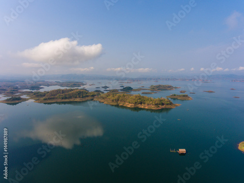 Aerial view of small islands in a lake at morning light © komjomo
