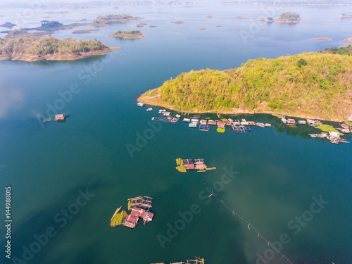 Aerial view of Village and fish farm among lake and mountain.