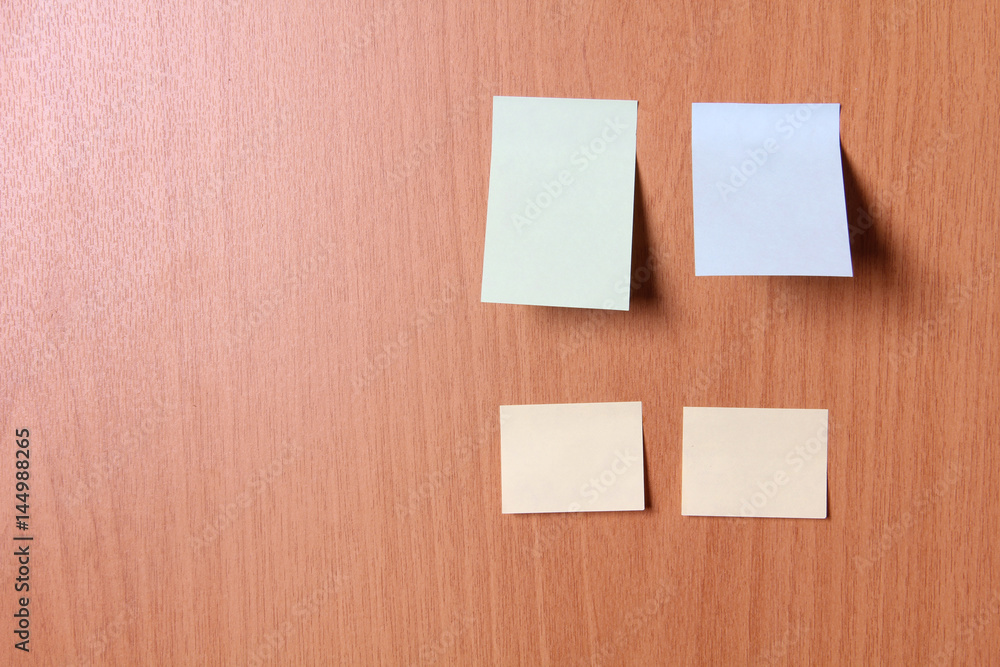 Empty sheets of paper on a wooden wall Empty sheets of paper on a wooden wall