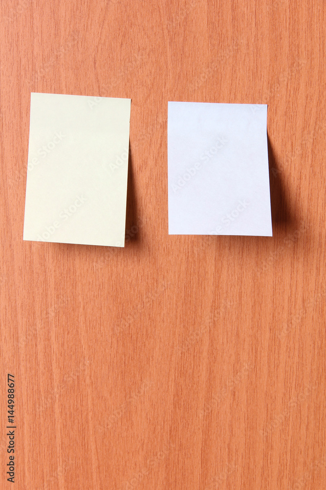 Empty sheets of paper on a wooden wall Empty sheets of paper on a wooden wall