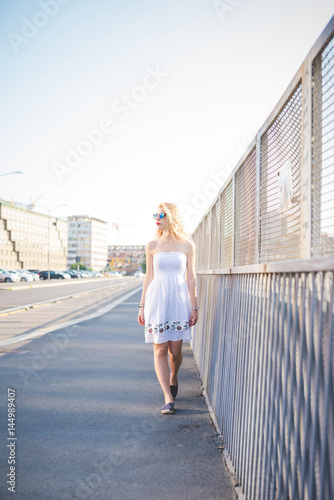 Young beautiful woman walking in the city - everyday life, city living, independence concept