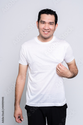 Handsome bearded man in a blank white t-shirt  on white background.