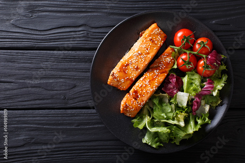 salmon in honey-soy glaze and fresh vegetable close-up. Horizontal top view photo