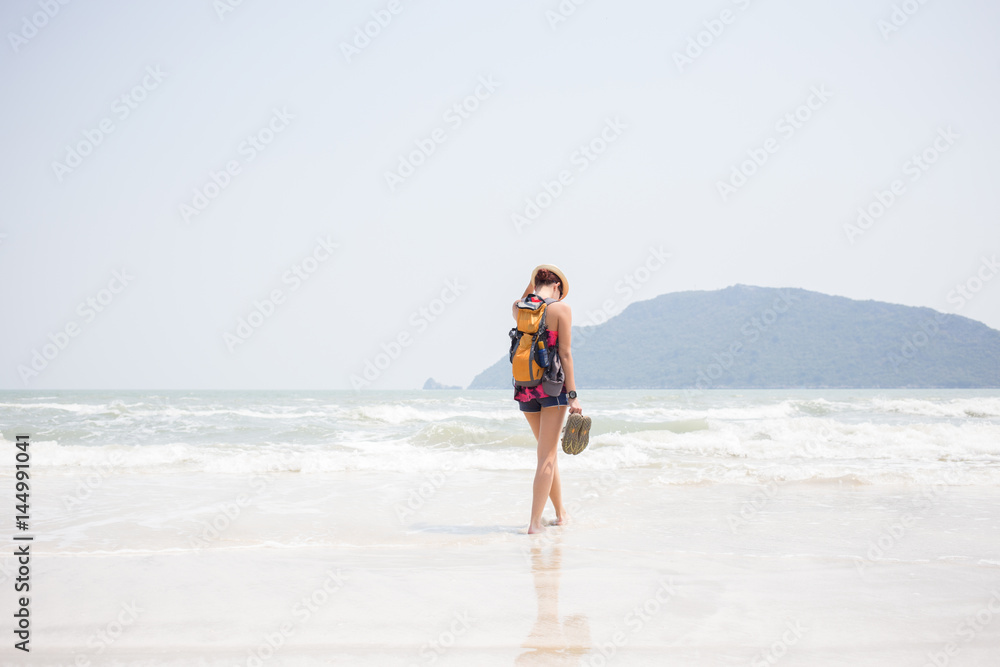 Woman in hat on seashore