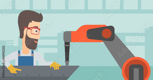 Man working on industrial welding robotic arm.