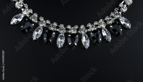 black and white jewelry with dark background. low key picture style of commercial product.