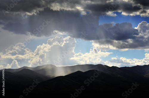 Sun Rays In Clouds and Mountains