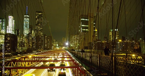 Manhattan skyline as seen on the Brooklyn Bridge at night.