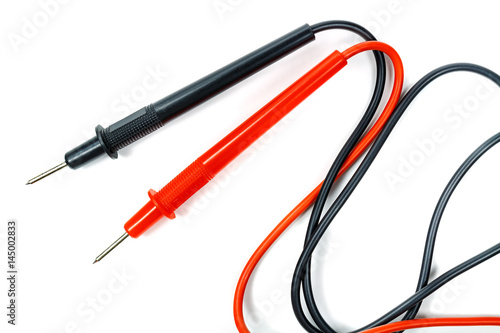 Red and black multimeter probes on a white background