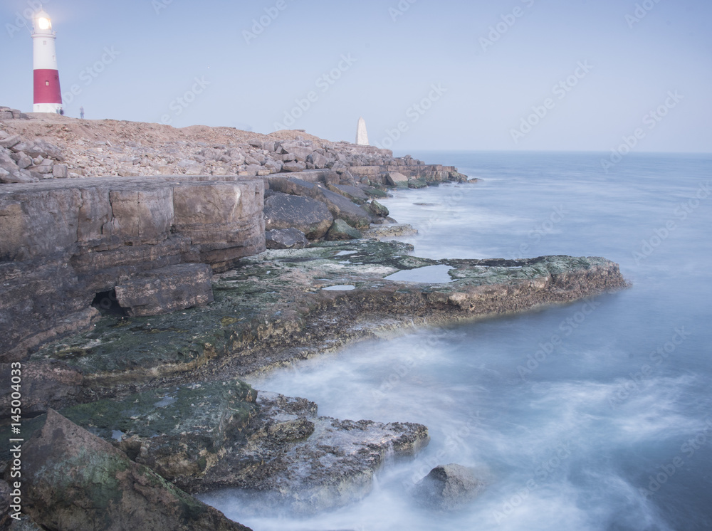 Rocks, waves and lighthouse