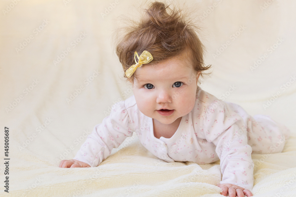 A small child laughing and learning to crawl. A small child laughing and learning to crawl.