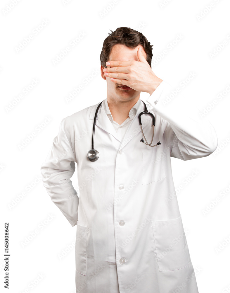 Tired doctor covering his eyes against white background Tired doctor covering his eyes against white background