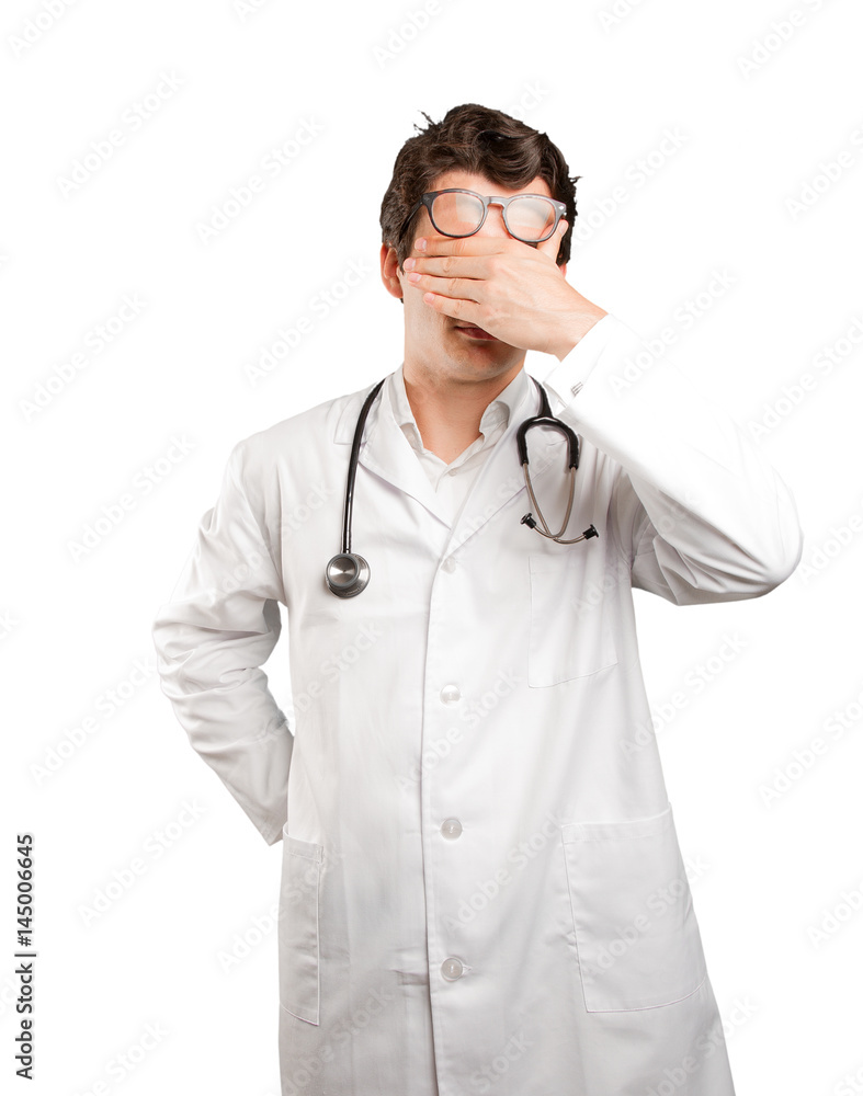 Tired doctor covering his eyes against white background Tired doctor covering his eyes against white background
