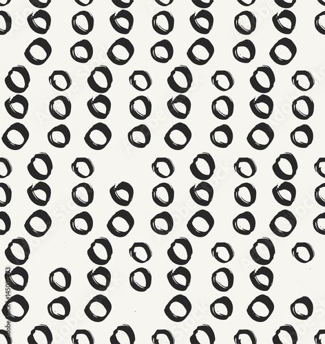 Monochrome irregular artistic background with rows of hand drawn circles. Repeating texture perfect for wallpapers, textile and decoration. Vector seamless pattern.
