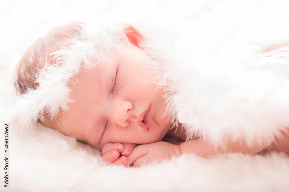 Infant baby with angel wings on neutral background Infant baby with angel wings on neutral background