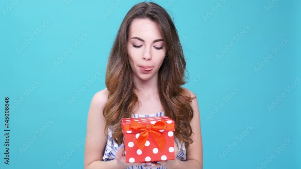Young smiling woman glad about gift isolated Young smiling woman glad about gift isolated