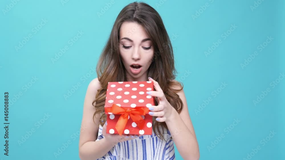 Young cute woman happy about gift isolated
Young cute woman happy about gift isolated