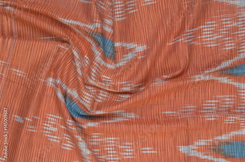 background of silk fabric with oriental ornaments. uzbek silk with ornament