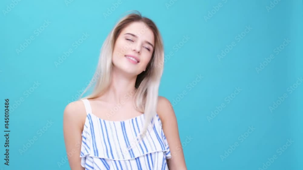 Young smiling blonde woman dancing against camera isolated Young smiling blonde woman dancing against camera isolated