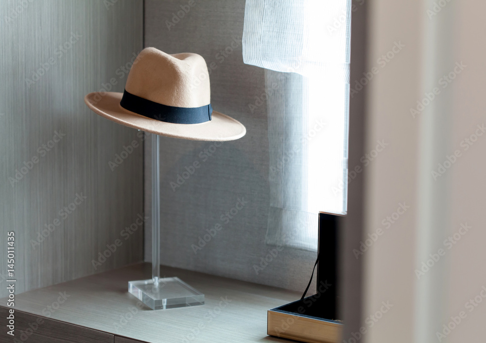 Brown hat with ribbon on dressing table, selective focus