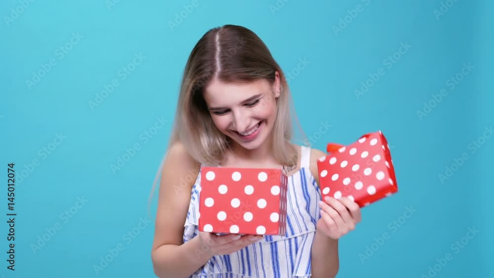 Young woman glad about gift isolated Young woman glad about gift isolated