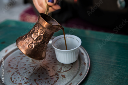 Traditional copper pot and cup of coffee in tavern in Sarajevo
 photo