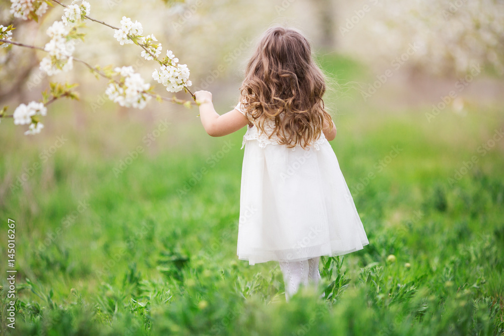 Pretty child girl in blossom garden Pretty child girl in blossom garden