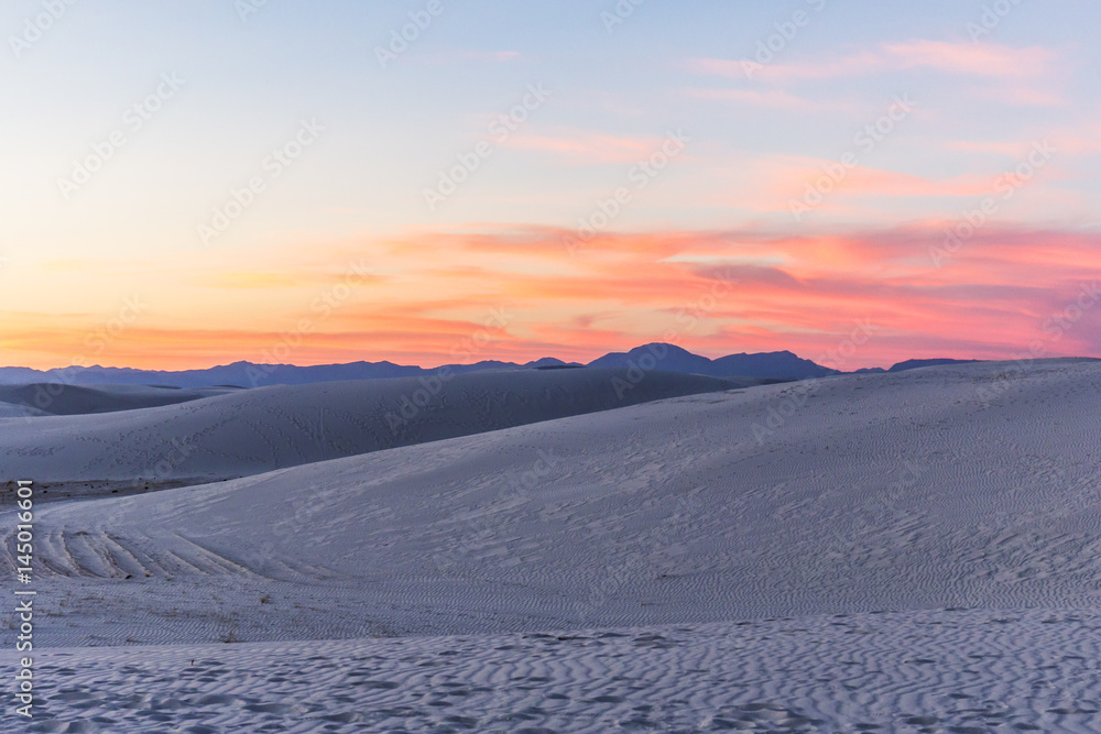 sunset over the mountains and white sand dunes sunset over the mountains and white sand dunes
