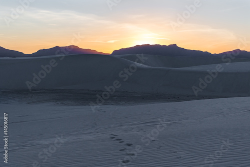 sunset over the sand dunes in the desert