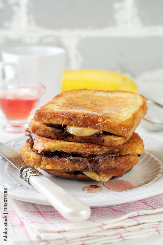Chocolate banana french toast on a light background. Selective focus. Chocolate banana french toast on a light background. Selective focus.