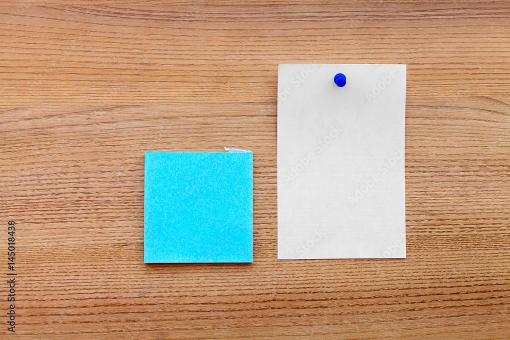 blue sticker with a white paper isolated on a wooden background blue sticker with a white paper isolated on a wooden background