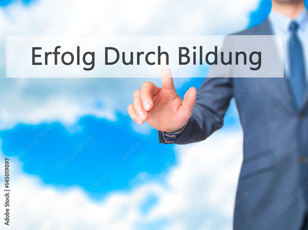 Erfolg Durch Bildung (Success Through Training in German) - Businessman hand pressing button on touch screen interface. Erfolg Durch Bildung (Success Through Training in German) - Businessman hand pressing button on touch screen interface.