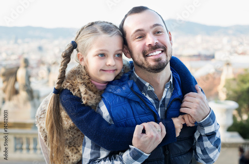 Smiling man and daughter exploring city